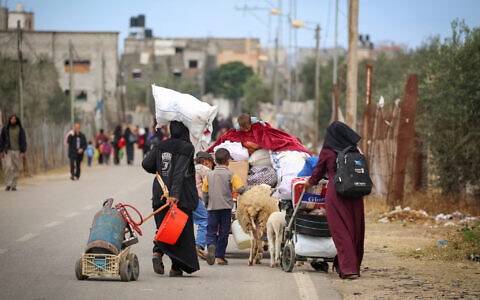 Palestinians in Rafah in the southern Gaza Strip carry their belongings following a call to evacuate  by the Israeli army on May 6, 2024 (AFP)