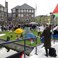Pro-Palestinian and anti-Israel students wave Palestinian flags and placards as they occupy Amsterdam University campus on May 6, 2024. (Nick Gammon / AFP)