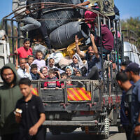 Displaced Palestinians flee Rafah with their belongings to safer areas in the southern Gaza Strip on May 7, 2024 following an evacuation order by the Israeli army the previous day(Photo by AFP)