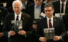 US President Joe Biden (L) and House Speaker Mike Johnson hold images of Holocaust victims during the annual Days of Remembrance ceremony for Holocaust survivors at the US Capitol in Washington, DC, on May 7, 2024. (Brendan Smialowski/AFP)