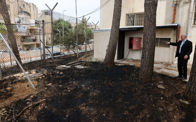 United Nations Relief and Works Agency for Palestine Refugees (UNRWA) Affairs Director in the West Bank Adam Bouloukos visits the agency's headquarters in east Jerusalem, where the traces of a fire are visible after "Israeli extremists" allegedly set ablaze the perimeter of the building on May 10, 2024. (AHMAD GHARABLI / AFP)