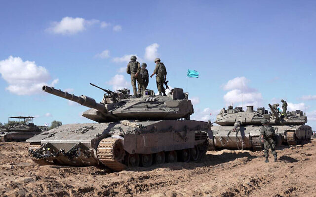 IDF soldiers standing atop a battle tank as part of the Givati Brigade operating in eastern Rafah in the southern Gaza Strip, in a handout picture released on May 10, 2024. (Israel Defense Forces/AFP)