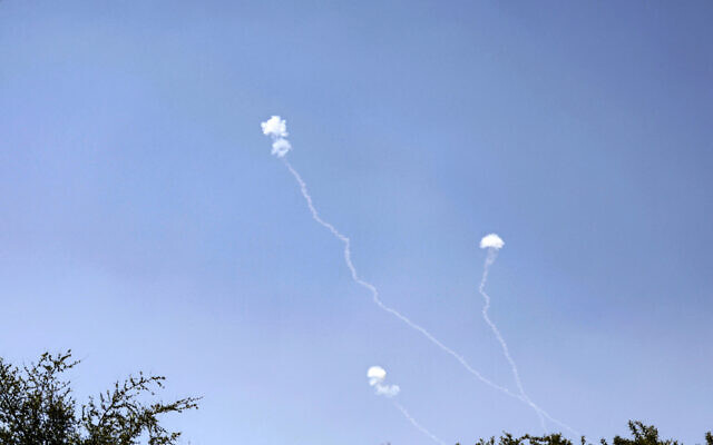 Illustrative - Rockets fired from southern Lebanon are intercepted by Israel's Iron Dome air defense system over the Golan Heights on May 16, 2024. (Jalaa Marey/AFP)