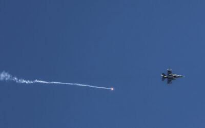 An Israeli fighter jet is seen firing a flare over southern Lebanon on May 16, 2024. (Menahem Kahana / AFP)