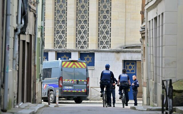 Police patrol outside a synagogue in the Normandy city of Rouen where French police killed an armed man who was trying to set fire to the building on May 17, 2024. (Lou Benoist/AFP)