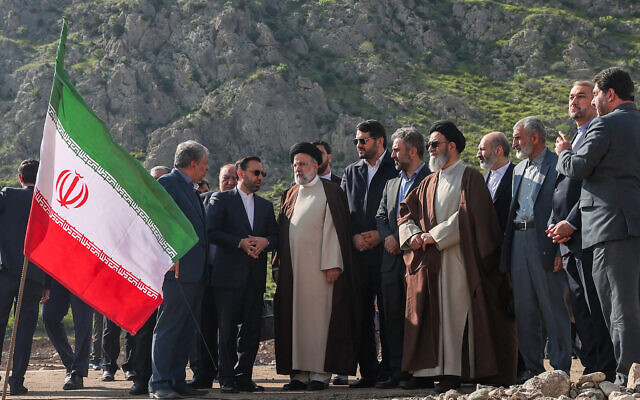 A handout picture provided by the Iranian presidency shows Iran's President Ebrahim Raisi (C) at the site of Qiz Qalasi, the third dam jointly built by Iran and Azerbaijan on the Aras River, ahead of its inauguration ceremony on May 19, 2024. (Iranian Presidency/AFP)