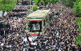 People participate in a funeral procession alongside a truck carrying the coffins of president Ebrahim Raisi and his seven aides in Tabriz, East Azerbaijan province, on May 21, 2024 (ATA DADASHI / MOJ News Agency / AFP)