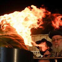 Chief Rabbi Yitzhak Yosef speaks as ultra-Orthodox Jewish men celebrate the holiday of Lag B'Omer in the Sheikh Jarrah neighborhood of East Jerusalem on May 25, 2024. (Ahmad Gharabli/AFP)