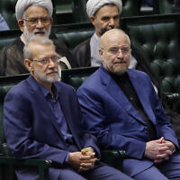 Former Iranian parliament speaker Ali Larijani (L) and reelected speaker Mohammad Bagher Qalibaf (R) attend the inauguration session for the new Parliament in Tehran on May 27, 2024. (AFP)