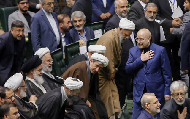 Iran's Parliament Speaker Mohammad Bagher Qalibaf (R) greets lawmakers during the inauguration session for the new Parliament in Tehran on May 27, 2024. (AFP)