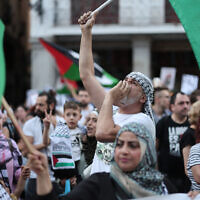 Pro-Palestinian protestors wave Palestinian flags as they demonstrate against Israel in front of the Spanish foreign ministry in Madrid, on May 27, 2024. (Thomas Coex/AFP)