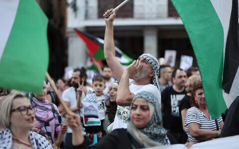 Pro-Palestinian protestors wave Palestinian flags as they demonstrate against Israel in front of the Spanish foreign ministry in Madrid, on May 27, 2024. (Thomas Coex/AFP)