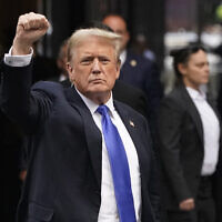 Former US president and Republican presidential candidate Donald Trump holds up a fist as he arrives back at Trump Tower after being convicted in his criminal trial in New York City, on May 30, 2024. (Timothy A. Clary/AFP)