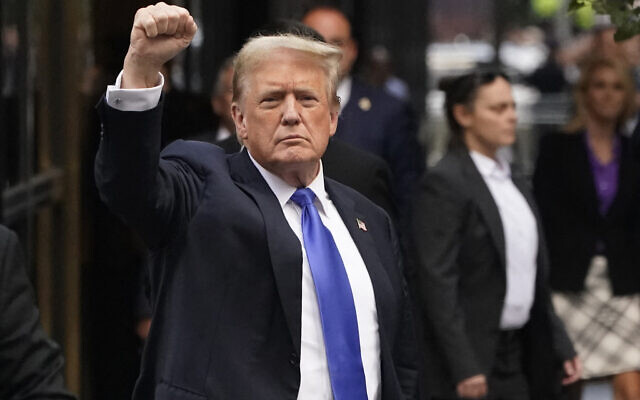 Former US president and Republican presidential candidate Donald Trump holds up a fist as he arrives back at Trump Tower after being convicted in his criminal trial in New York City, on May 30, 2024. (Timothy A. Clary/AFP)