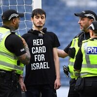 A demonstrator wearing a t-shirt reading 'Red card for Israel' chained himself to the goal post prior to the UEFA Women's Euro 2025 League B Group 2 qualifying soccer match between Scotland and Israel at Hampden Park stadium in Glasgow, Scotland, on May 31, 2024. (ANDY BUCHANAN / AFP)