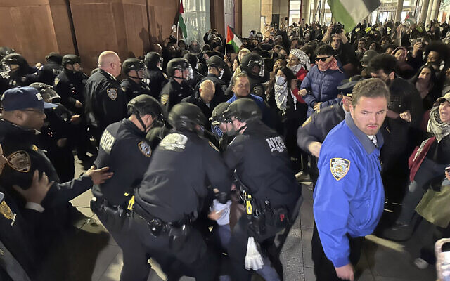 File - New York City Police Department officers arrest anti-Israel and pro-Palestinian protesters outside a student-led encampment at New York University on April 22, 2024. (AP Photo/Noreen Nasir)