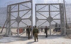 IDF soldiers gather near a gate toward an inspection area for trucks carrying humanitarian aid supplies bound for the Gaza Strip, on the Israeli side of the Erez Crossing into Gaza, May 1, 2024. (AP Photo/Ohad Zwigenberg)