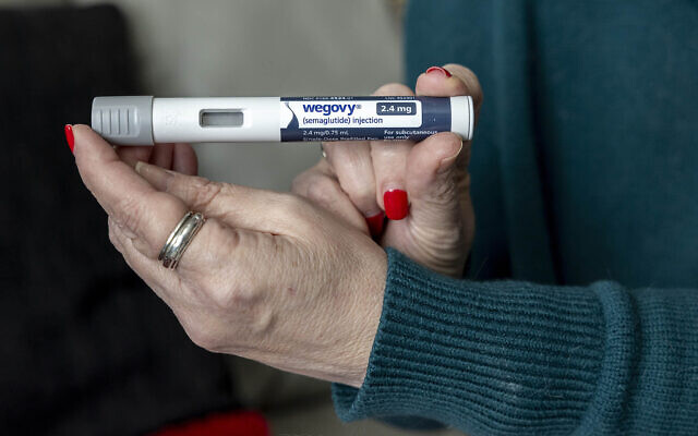 Illustrative: Woman holds up a dosage of Wegovy, a drug used for weight loss, in Front Royal, Virginia, March 1, 2024. (AP Photo/Amanda Andrade-Rhoades)