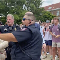 In this photo taken from video provided by Stacey J. Spiehler, a pro-Palestinian protester is confronted by hecklers at the University of Mississippi, May 2, 2024, in Oxford, Mississippi. (Stacey J. Spiehler via AP)