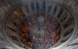 Christian pilgrims hold candles during the Holy Fire ceremony, a day before Easter, at the Church of the Holy Sepulcher, where many Christians believe Jesus was crucified, buried and resurrected, in Jerusalem's Old City, May 4, 2024. (Ohad Zwigenberg/AP)