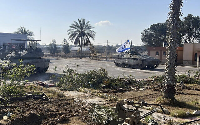 File: This photo provided by the Israel Defense Forces shows a tank with an Israeli flag on it entering the Gazan side of the Rafah Border Crossing on Tuesday, May 7, 2024. (Israel Defense Forces via AP)