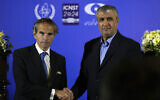 Director General Rafael Grossi of the International Atomic Energy Organization, IAEA, left, and head of Iran's atomic energy department Mohammad Eslami shake hands at the conclusion of their joint press conference after their meeting in the central city of Isfahan, Iran, Tuesday, May 7, 2024. (AP Photo/Vahid Salemi)