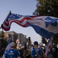 A pro-Israel supporter waves a flag while marching outside the University of Southern California campus in Los Angeles, May 8, 2024. (AP Photo/Jae C. Hong)
