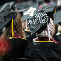 A student sits with her cap decorated to read "Free Palestine" while attending the University of Minnesota's College of Liberal Arts graduation ceremony, on May 12, 2024, in Minneapolis, Minnesota. (Angelina Katsanis/AP)