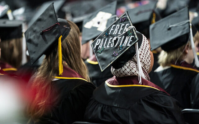 A student sits with her cap decorated to read "Free Palestine" while attending the University of Minnesota's College of Liberal Arts graduation ceremony, on May 12, 2024, in Minneapolis, Minnesota. (Angelina Katsanis/AP)