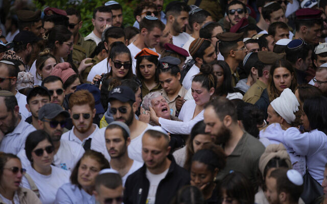 Family members and friends of fallen soldiers visit their graves on Memorial Day at Mount Herzl military cemetery in Jerusalem, May 13, 2024. (AP Photo/Ohad Zwigenberg)