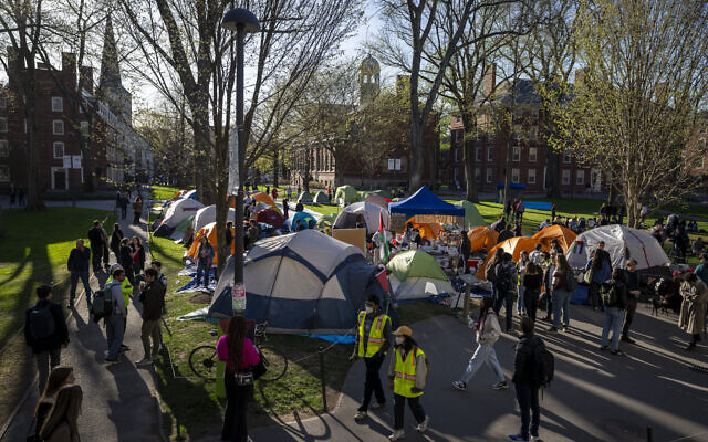 Students protesting against the war in Gaza, and passersby walking through Harvard Yard, are seen at an encampment at Harvard University in Cambridge, Massachusetts, April 25, 2024. (AP Photo/Ben Curtis, File)