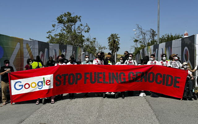 Demonstrators carry a banner and block an entrance to the Google I/O conference in Mountain View, California on May 14, 2024. (AP Photo/Terry Chea)