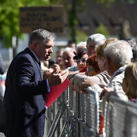 Slovakia's Prime Minister Robert Fico, center, speaks with people before the cabinet's away-from-home session in the town of Handlova, Slovakia, May 15, 2024. (Radovan Stoklasa/TASR via AP)