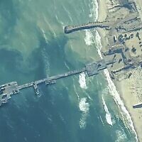 The image provided by US Central Command shows US Army soldiers assigned to the 7th Transportation Brigade (Expeditionary), US Navy sailors assigned to Amphibious Construction Battalion 1, and Israel Defense Forces placing the Trident Pier on the coast of Gaza Strip on Thursday, May 16, 2024. (US Central Command via AP)