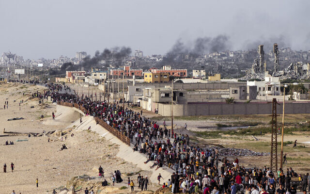 Palestinians wait for aid trucks to cross in central Gaza Strip, May 19, 2024. (AP Photo/ Abdel Kareem Hana)