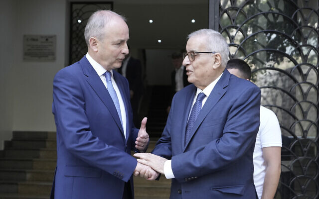 Lebanese Foreign Minister Abdallah Bouhabib, right, shakes hands with Ireland's Deputy Prime Minister and Foreign Minister Micheal Martin after their meeting in Beirut, Lebanon, Monday, May 20, 2024. (AP Photo/Hassan Ammar)