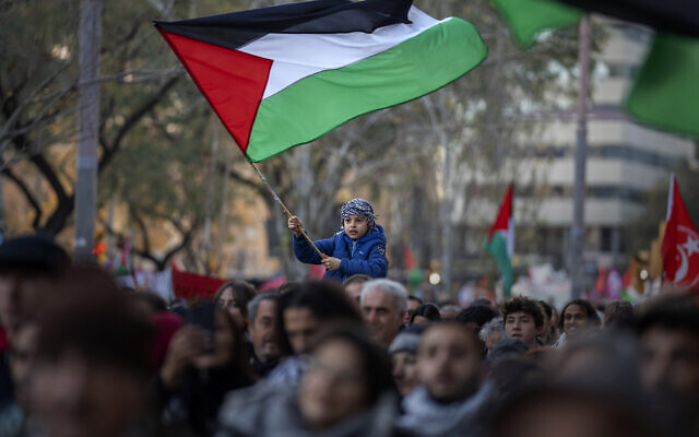 Illustrative: A boy waves a Palestinian flag as demonstrators march during a protest in support of Palestinians and calling for an immediate ceasefire in Gaza, in Barcelona, Spain, on January 20, 2024. (AP Photo/Emilio Morenatti, File)