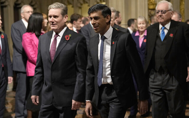 Britain's Prime Minister Rishi Sunak, right, and Labour Party leader Keir Starmer pass through the Peer's Lobby to attend the State Opening of Parliament, at the Palace of Westminster in London, Nov. 7, 2023. (AP Photo/Alastair Grant, Pool, File)