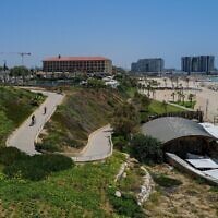 Israelis enjoy a sunny summer day at the Zvulun beach in Herzliya on June 27, 2023. (Michael Giladi/Flash90)