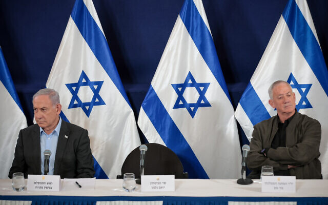 Prime minister Benjamin Netanyahu sits during a press conference along with Minister Benny Gantz at the Defense Ministry headquarters in Tel Aviv, December 16, 2023. (Noam Revkin Fenton/Flash90)