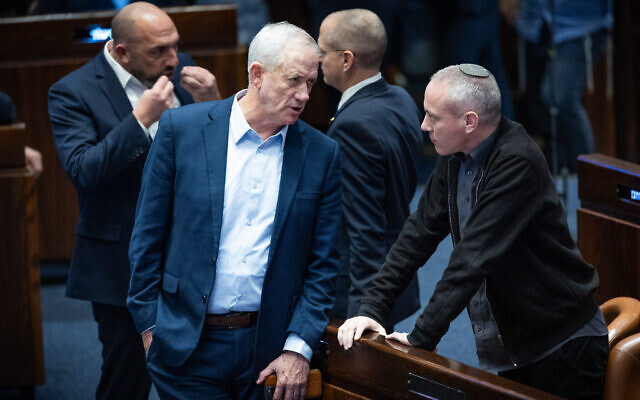 Minister Benny Gantz speaks with MK Chilli Tropper at a vote on the state budget at the Knesset in Jerusalem, February 7, 2024.(Yonatan Sindel/Flash90)