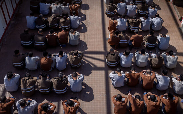 Hamas terrorists who were caught during the October 7 massacre and during the IDF operation in the Gaza Strip, seen at a courtyard in a prison in southern Israel, February 14, 2024. (Chaim Goldberg/Flash90)