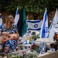 Hadas Hershkovitz, the widow of Israeli soldier Yossi Hershkovitz who was killed fighting in the Gaza Strip visits his grave on Israel's 76th Independence Day, at Mount Herzl Military Cemetery in Jerusalem on May 14, 2024. (Chaim Goldberg/Flash90)
