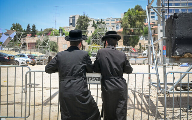 Haredi Jews watch preperations for the Lag B'Omer festivities at the Shimon HaTzadik tomb in Jerusalem on May 22, 2024. (Photo by Arie Leib Abrams/FLASH90)