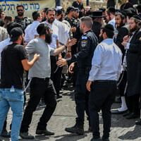 Police push back ultra-Orthodox men who tried to enter the Tomb of Rabbi Shimon bar Yochai on the Jewish holiday of Lag B'Omer, at Mount Meron, May 26, 2024. (David Cohen/Flash90)