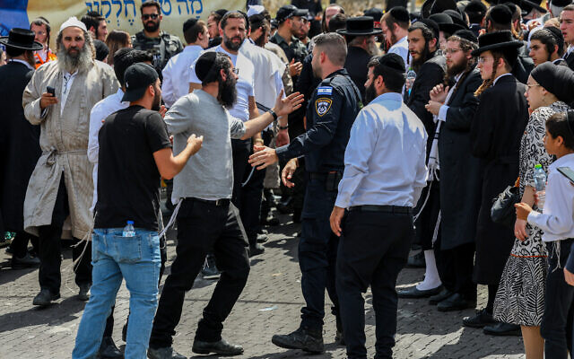 Police push back ultra-Orthodox men who tried to enter the Tomb of Rabbi Shimon bar Yochai on the Jewish holiday of Lag B'Omer, at Mount Meron, May 26, 2024. (David Cohen/Flash90)
