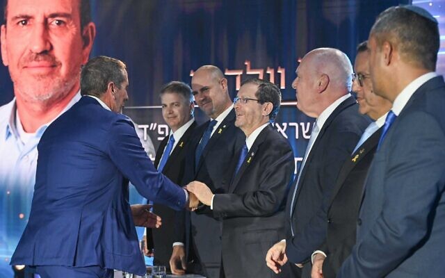 President Isaac Herzog shakes hands with Israel Prize recipient Eyal Waldman at the award ceremony in Sderot, May 14, 2024. (Maayan Toaf/GPO)
