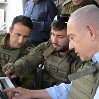 Prime Minister Benjamin Netanyahu speaks to soldiers during a visit to the northern border on May 28, 2024. (Amos Ben-Gershom/GPO)