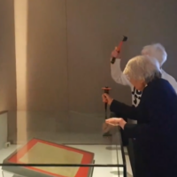 Two environmental activists attack a glass case containing an original copy of the Magna Carta at the British Library on  May 10, 2024 (Screencapture X: used in accordance with Clause 27a of the Copyright Law)