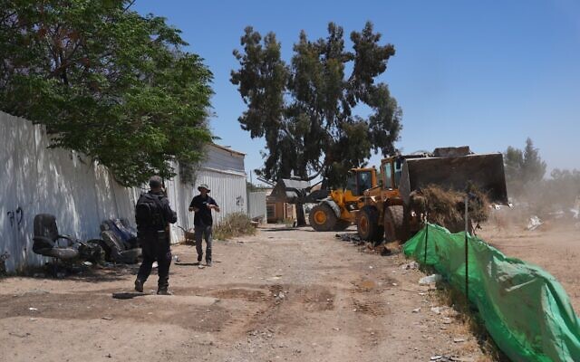 Police accompany Real Estate Enforcement Division tractors as they bulldoze the Wadi al-Khalil neighborhood in the southern Bedouin village of Umm Batin, May 8, 2024. (Israel Police)